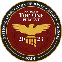 Circular badge with an eagle emblem in the center, labeled "Nation's Top One Percent 2023" and "National Association of Distinguished Counsel" around the edge.